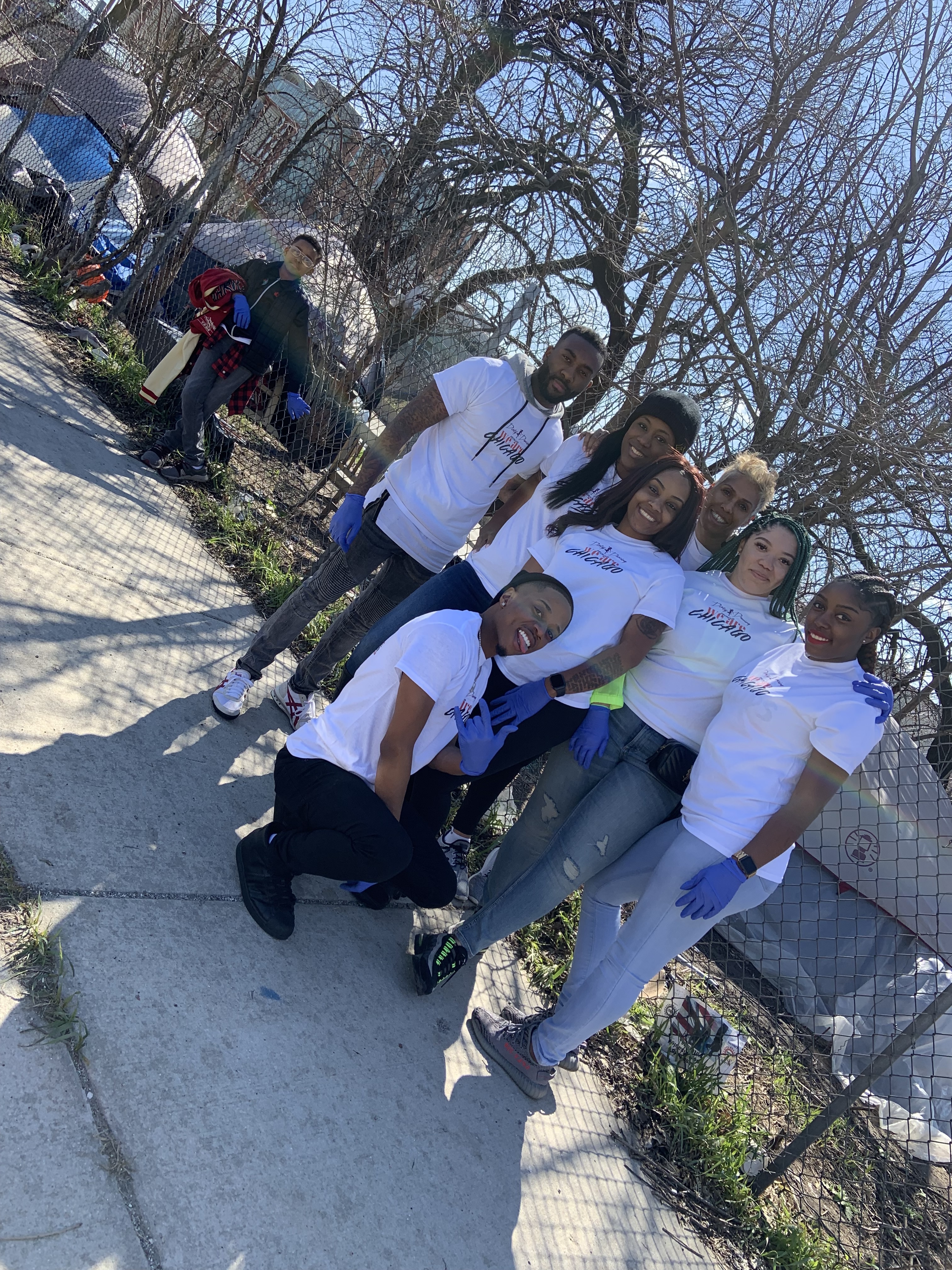 Volunteers gathered on the sidewalk during a direct neighborhood care day