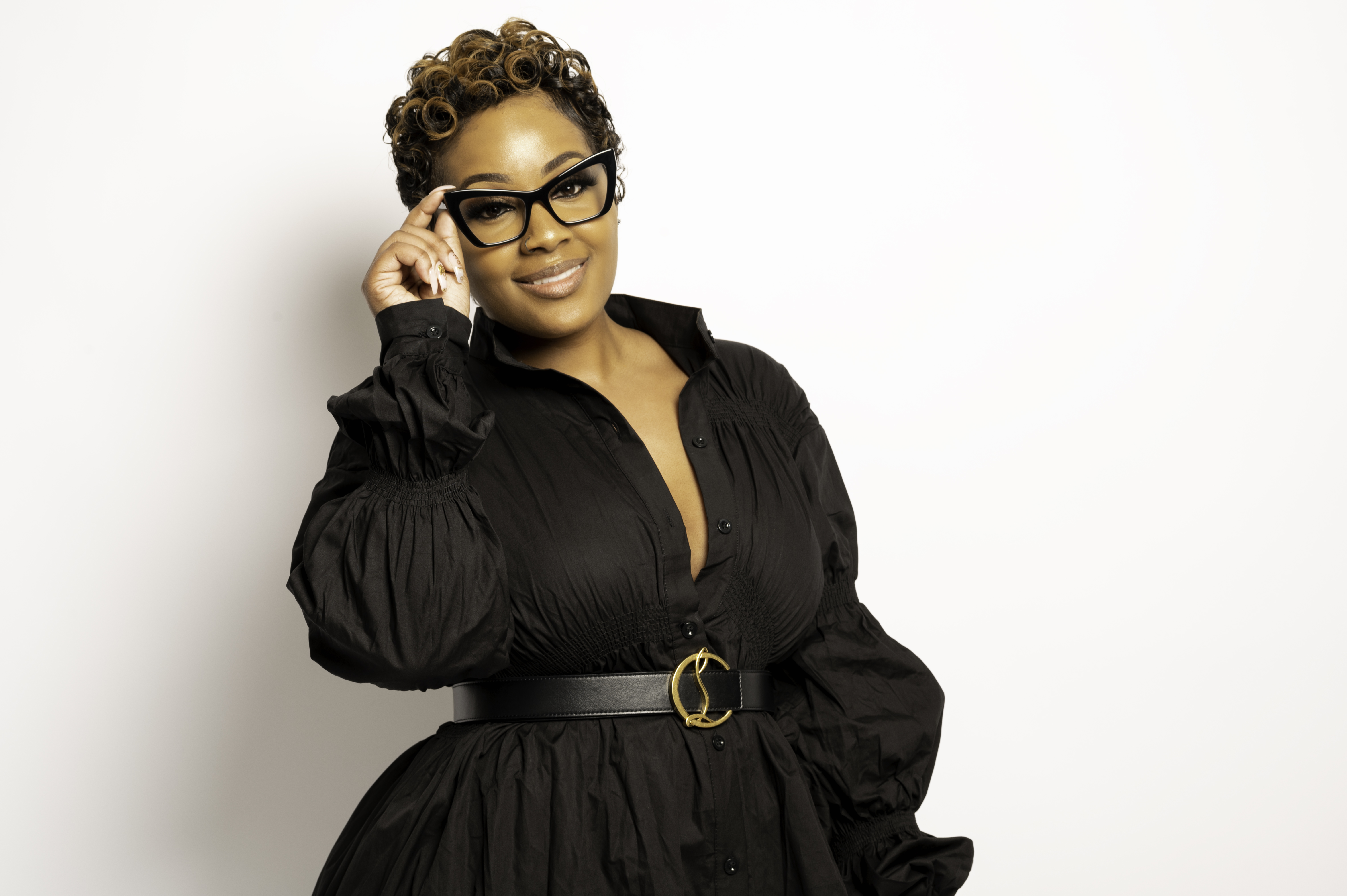 Ebony Shaw, Founder & Executive Director of I. AM. PHENOMENAL LLC, in a confident studio portrait